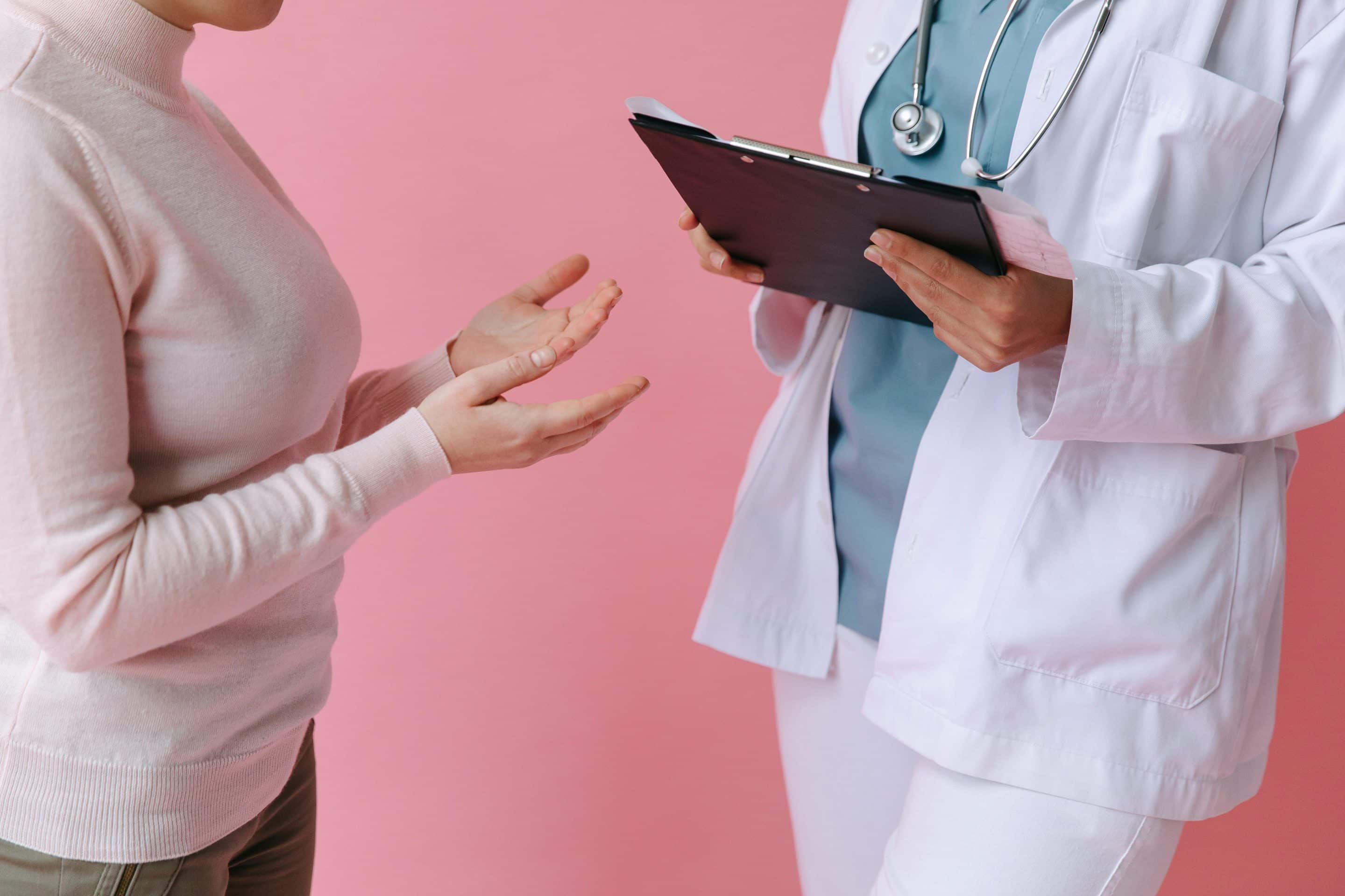 Patient talking to doctor with a clipboard